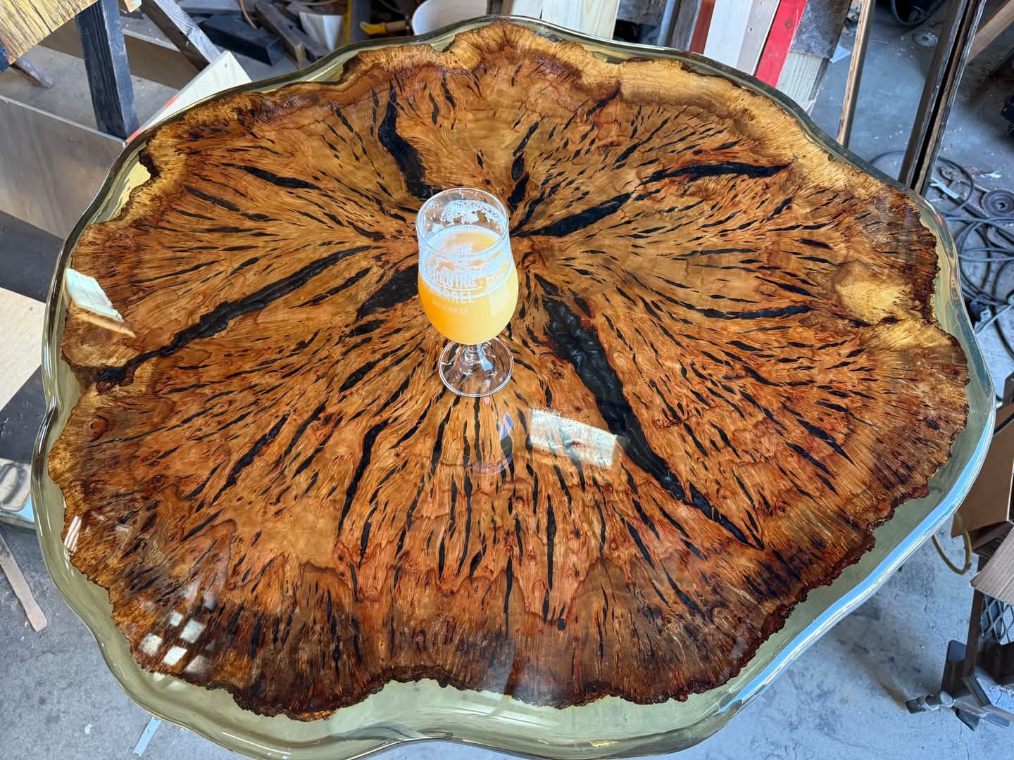 Camphor 'cookie' epoxy table with dramatic grain and clear resin edge.