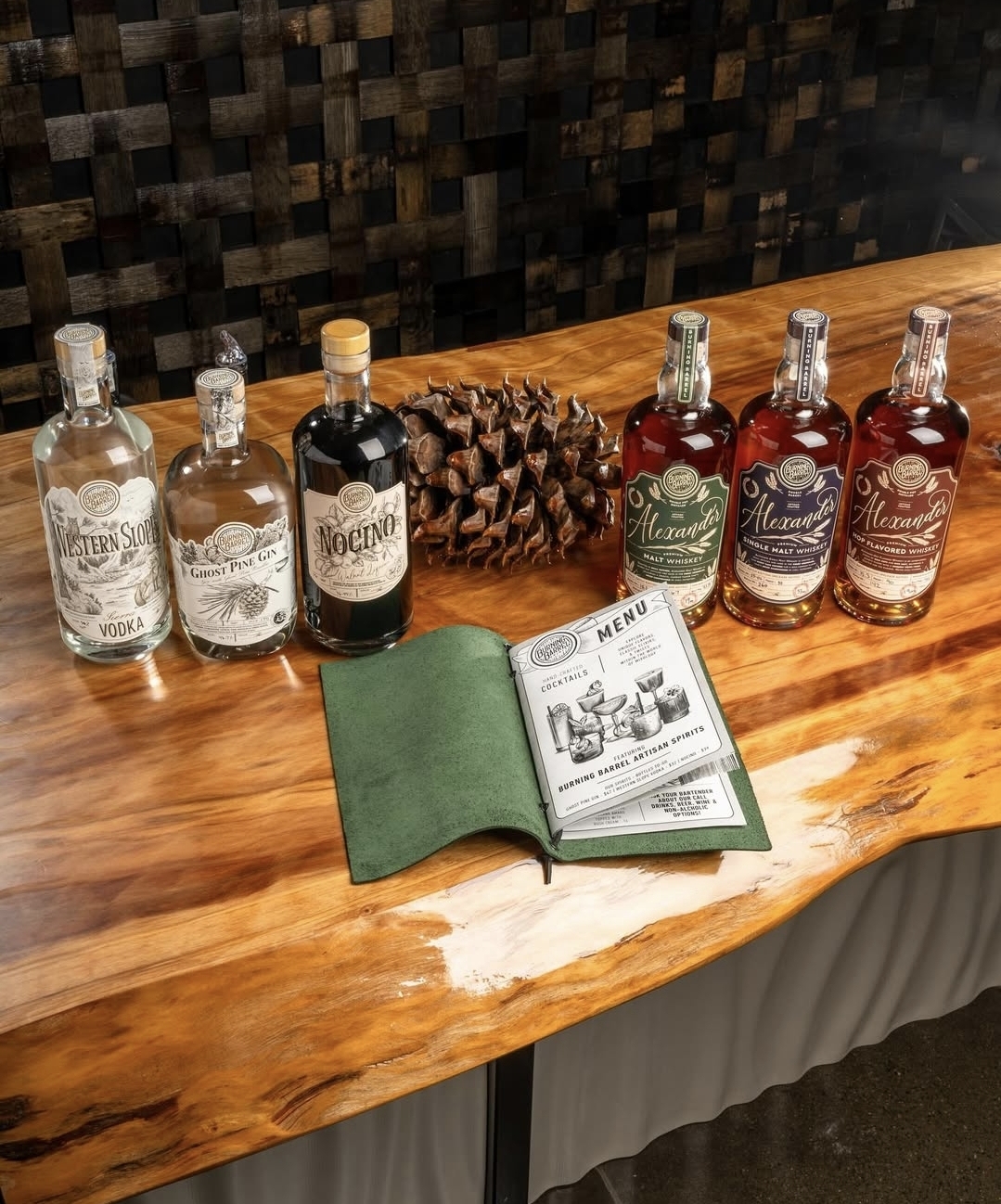 Jennifer with a member of the team behind a polished redwood bar at Burning Barrel.