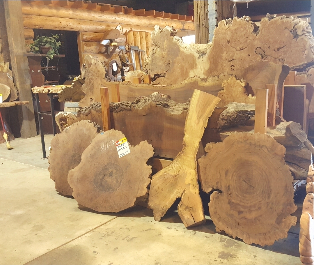 Multiple slabs of lumber leaned onto each other and the wall.